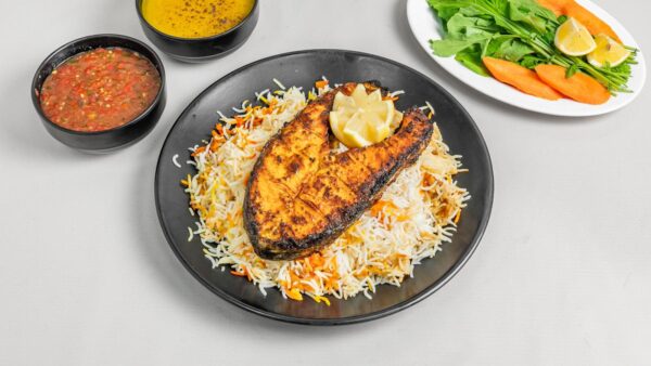 Grilled Salmon Fish Tender and juicy salmon fillet, grilled with herbs and spices. Served with veggies, lemon butter sauce, and your choice of rice or mashed potatoes.